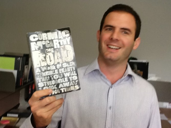 "If there are no more questions, let's take a look at the next novel we'll be discussing: Cormac McCarthy's The Road."